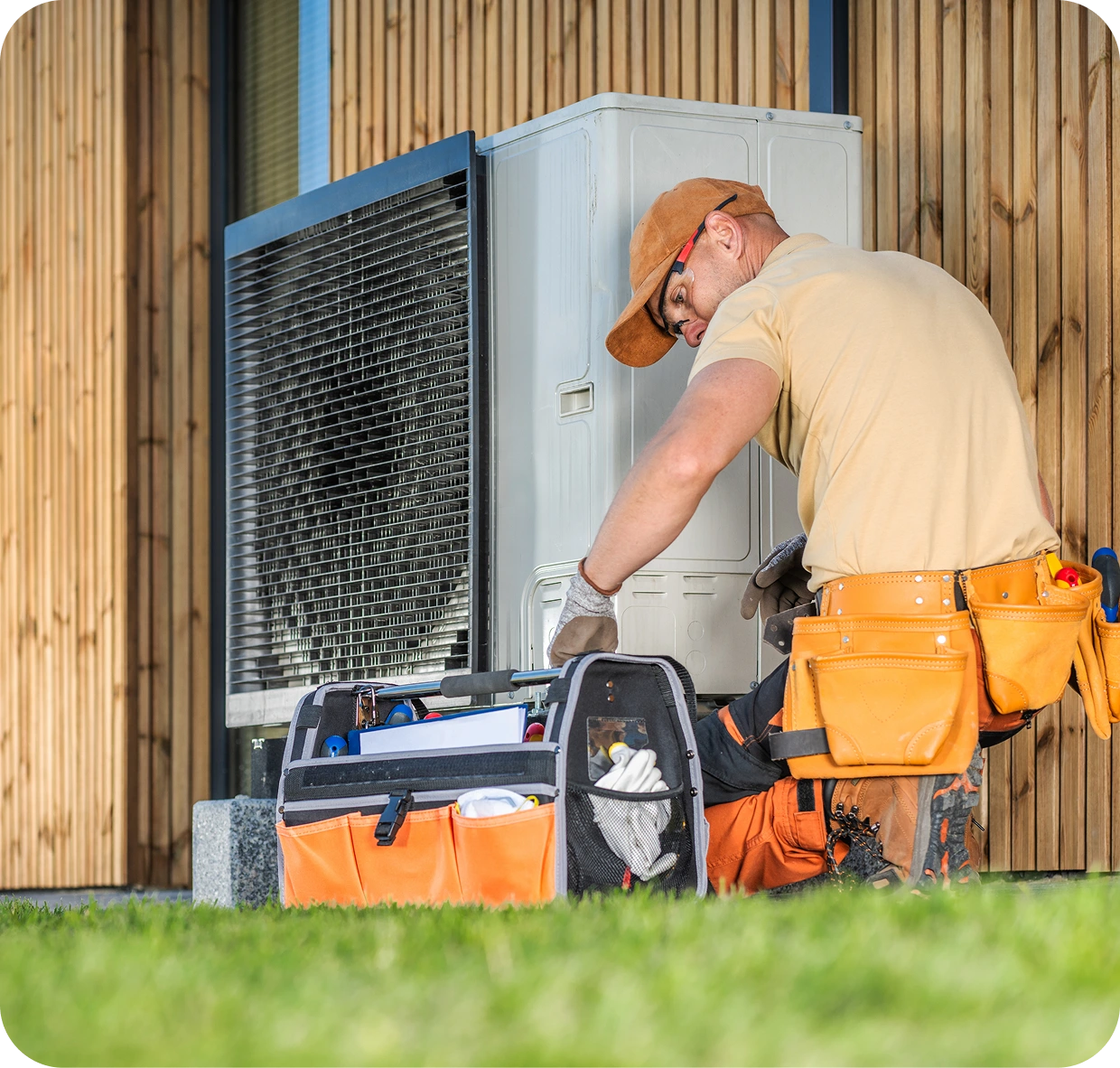Technician repairing outdoor HVAC unit, daytime.