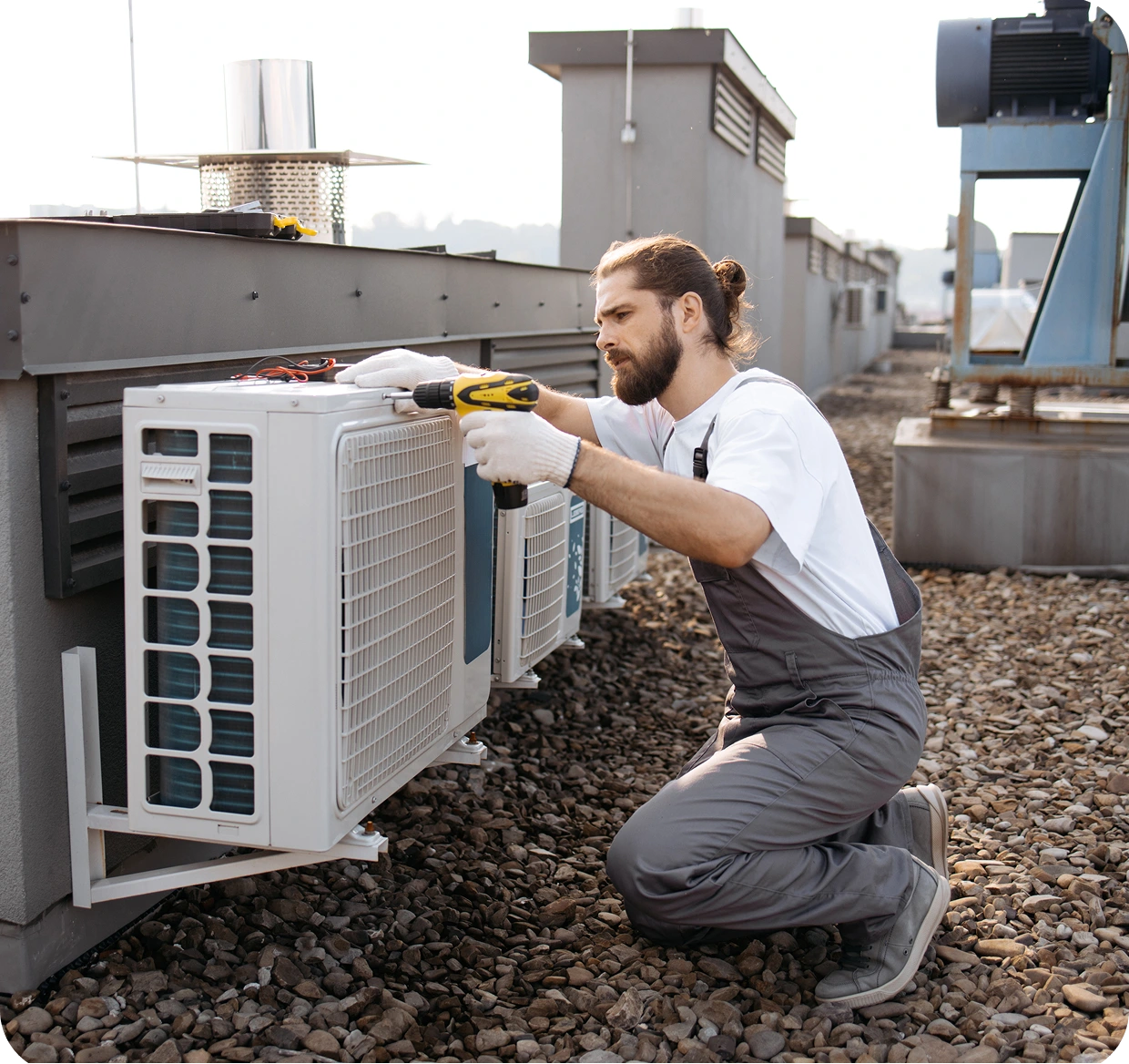 Technician repairing rooftop air conditioning unit.