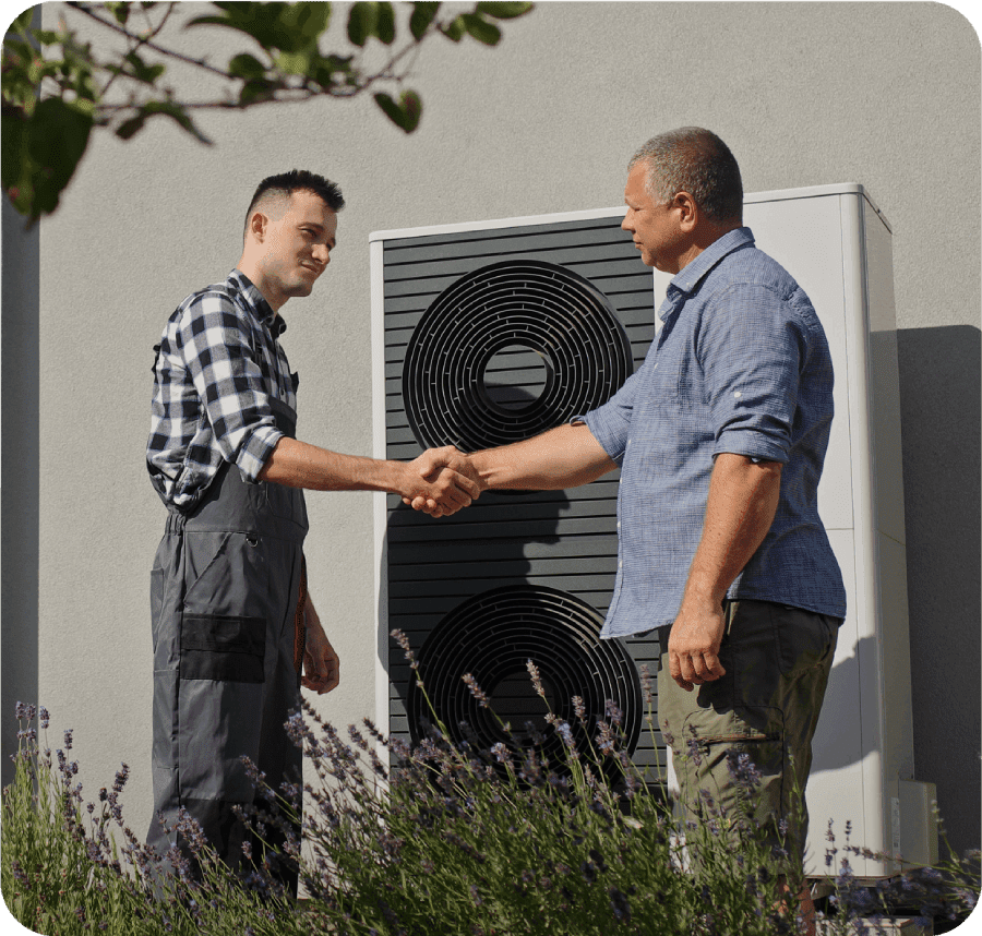 Two men shaking hands near outdoor unit.